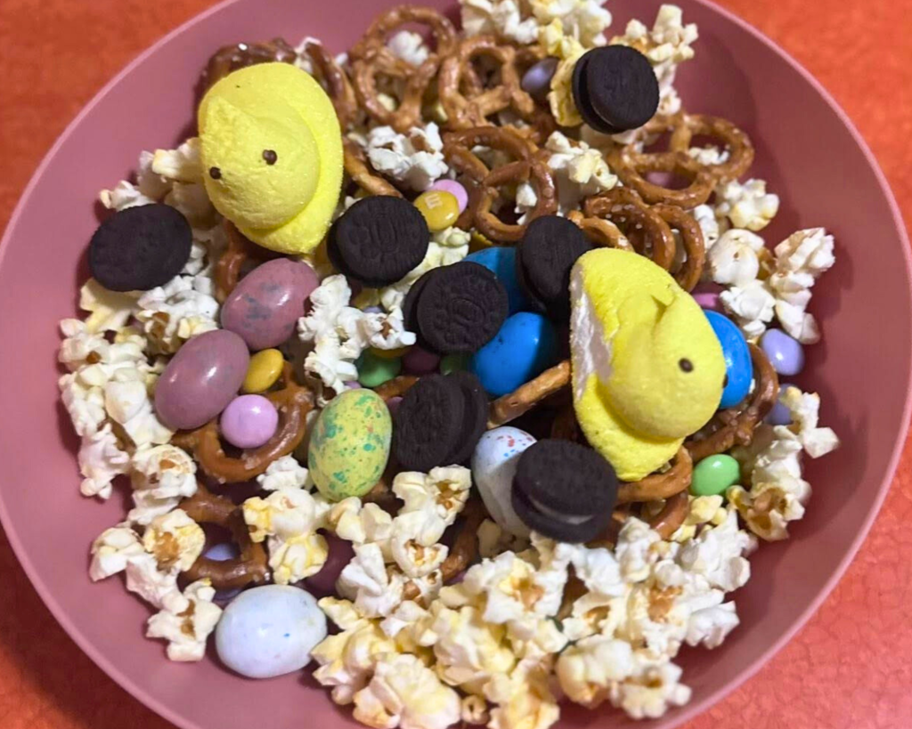 Easter snack mix ideas with mini Oreos, popcorn, chocolate eggs, pastel candy, and Peeps marshmallows